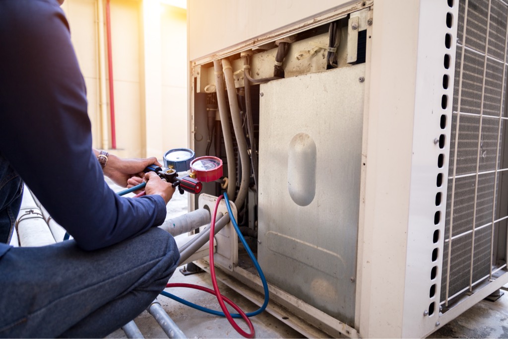 Workman checks heat pump after installation